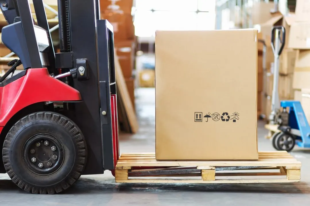 Forklift handling a pallet in a warehouse