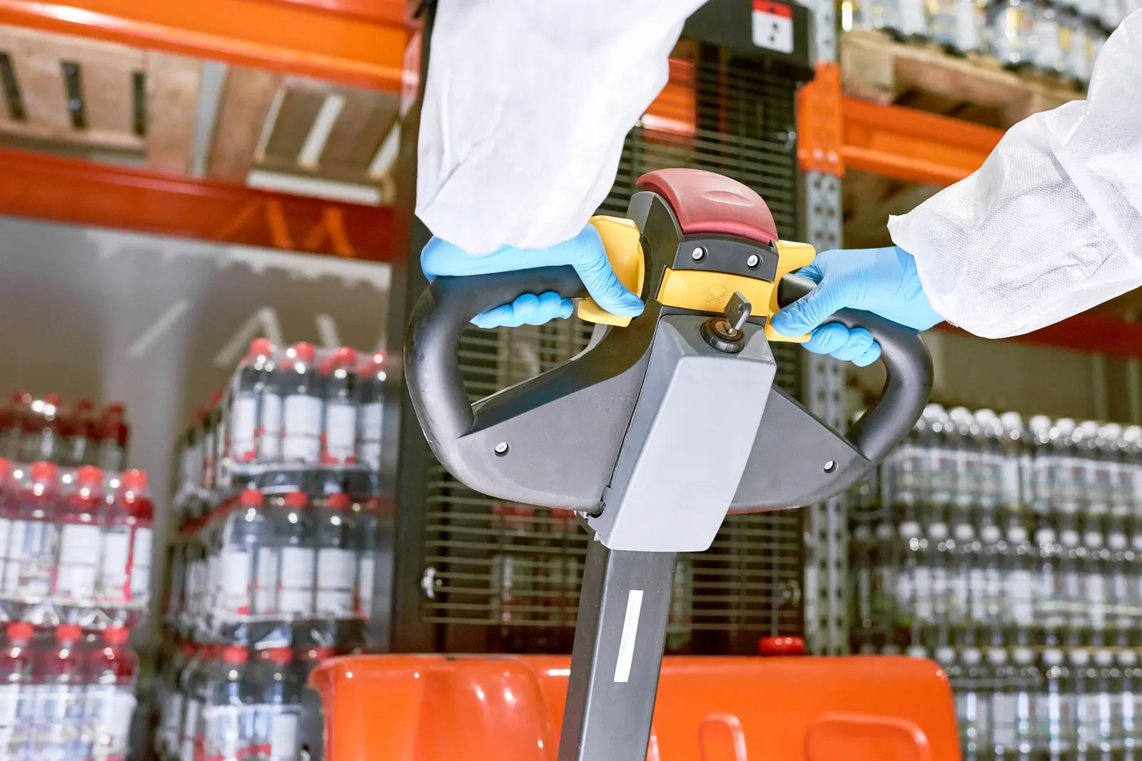 Electric pallet truck controls in a warehouse
